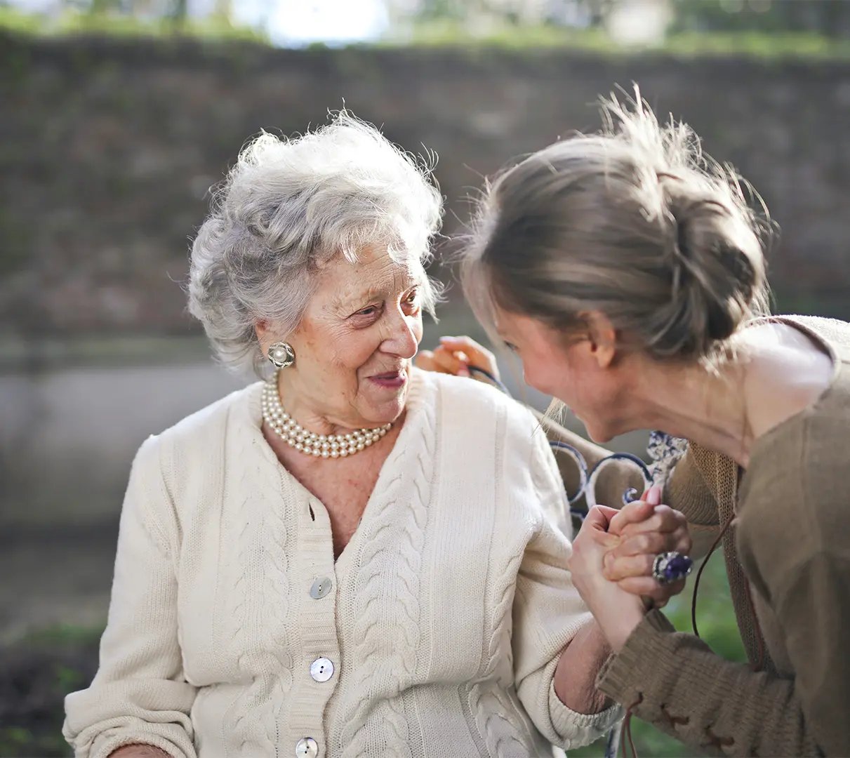 Lady and woman smiling at eachother