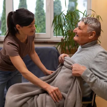 elderly-person-being-taken-care-by-female-caretaker 1
