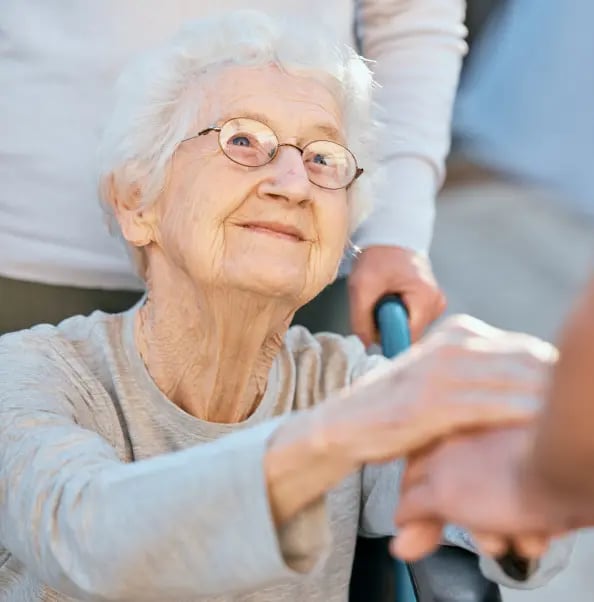 holding-hands-caregiver-senior-woman-wheelchair-support-outdoor-retirement-home-love-trust-healthcare-nurse-medical-wellness-doctor-disability-patient-with-kindness (1)