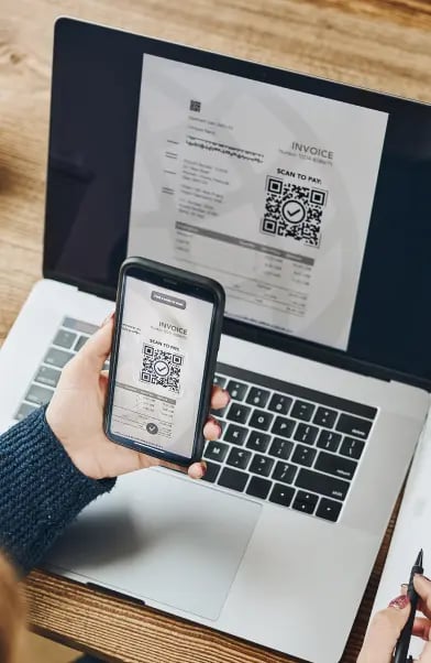 woman-scanning-qr-code-from-invoice-make-payment-using-fast-secure-payment-system-smartphone 1