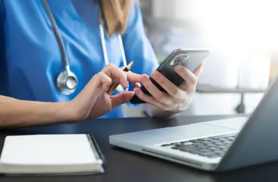 medical-technology-concept-doctor-working-with-mobile-phone-stethoscope-modern-office 1
